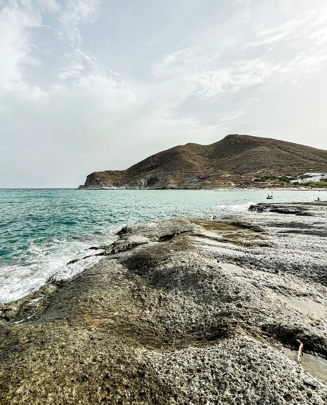 Vista volcánica del Cabo de Gata con formaciones rocosas y mar en calma.